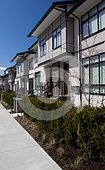 Brand new upscale townhomes in a Canadian neighbourhood. External facade of a row of colorful modern urban townhouses.brand new ho