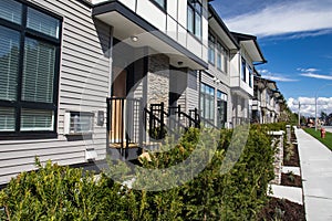 Brand new upscale townhomes in a Canadian neighbourhood. External facade of a row of colorful modern urban townhouses.brand new ho