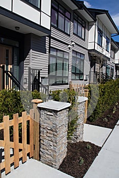 Brand new upscale townhomes in a Canadian neighbourhood. External facade of a row of colorful modern urban townhouses.brand new ho