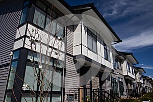 Brand new upscale townhomes in a Canadian neighbourhood. External facade of a row of colorful modern urban townhouses.brand new ho