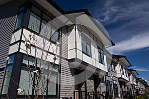 Brand new upscale townhomes in a Canadian neighbourhood. External facade of a row of colorful modern urban townhouses.brand new ho