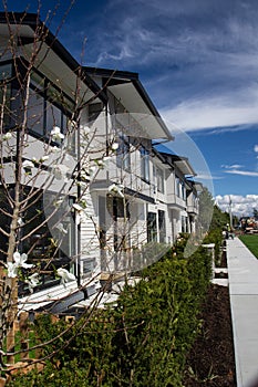 Brand new upscale townhomes in a Canadian neighbourhood. External facade of a row of colorful modern urban townhouses.brand new ho