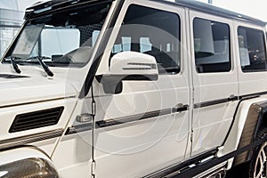 Brand new white jeep with chromed parts parked inside the building