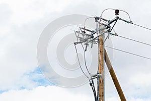 Brand new wooden electricity pole in a gray cloudy day