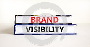Brand visibility symbol. Concept words Brand visibility on books. Beautiful white table white background. Business branding and photo