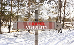 Brand visibility symbol. Concept words Brand visibility on beautiful wooden road sign. Beautiful forest snow blue sky background.