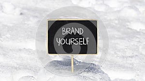 Brand yourself symbol. Concept words Brand yourself on beautiful black blackboard. Beautiful snow background. Business brand
