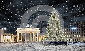 Brandenburg Gate in Berlin, with Christmas tree and snow photo