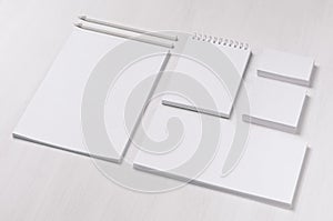 Branding business mock up of white blank stationery set on light soft white wooden background, inclined. photo