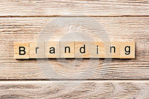 Branding word written on wood block. branding text on table, concept