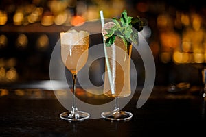 Brandy Crusta and Sherry Cobbler standing on the bar counter