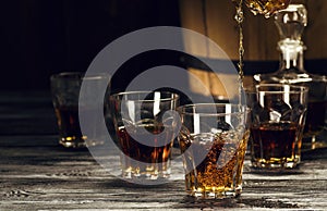 brandy in decanters stand on an oak barrel