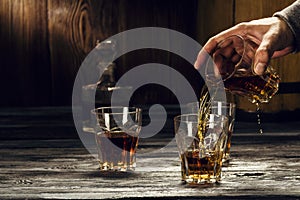 Brandy in decanters stand on an oak barrel