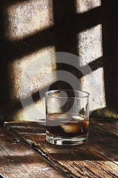 Brandy gBrandy glass on rustic background and rustic wooden table