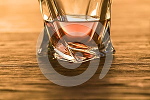 Brandy in glass on wooden table