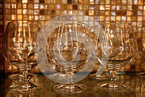 Brandy glasses against restaurant bar background
