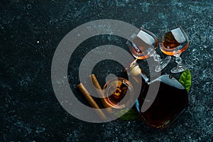 Brandy in glasses on a black stone table.