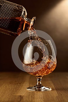 Brandy is poured into a snifter glass