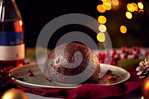 Brandy Soaked Christmas Pudding On Table Set For Festive Christmas Meal