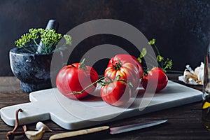 Brandywine sort tomatoes with ingredients for seasonal canning