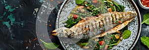 Branzino or Seabass Fillet with Bisque Sauce and Spinach with Grilled Spigola or Sea Bass on Dark Stone