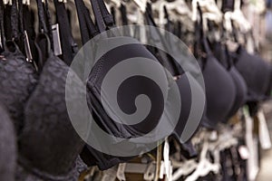 Bras on hangers in a lingerie store. Comfortable underwear without wires. Fashion and health. Close-up