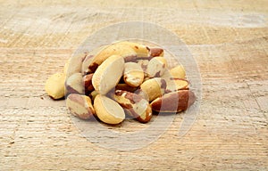 Brasil nuts in the group on wooden plank photo