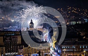 Brasov cityscape by night on new years eve with fireworks