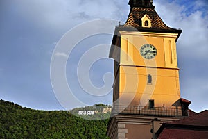Brasov townhall with a sign on the hill