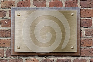 Brass or bronze metal plate on brickwall