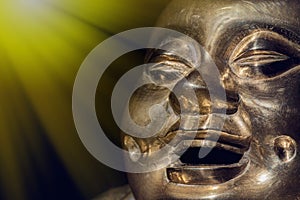 Brass buddha. Happy laughing enlightened monk face photo