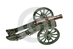 Brass cannon on green painted carriage old vintage isolated on w