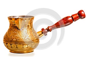 Brass coffee pot with wooden handle on a white background