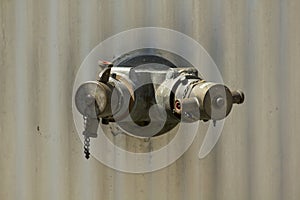 Brass fire extinguisher on white wall