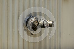 Brass fire extinguisher on white wall