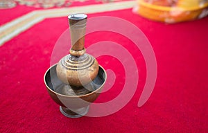 Brass gold in a pot placed on a red carpet