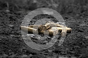 Brass gun shells lying on the black ground