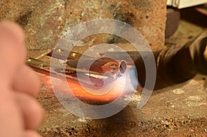 A brass item is being silver soldered with a gas torch