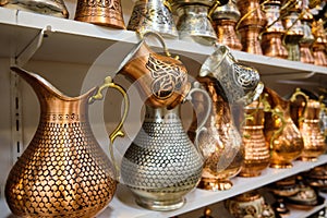 Brass jugs at shelf of souvenir store