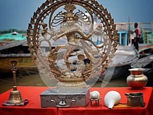 Brass made statue of Lord Natraj with water droplets near Ganges river in Varanasi, India.