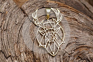 Brass metal pendant on natural background