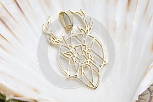 Brass metal pendant on natural background