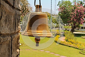 A brass mettle bell at front with beutiful background photo