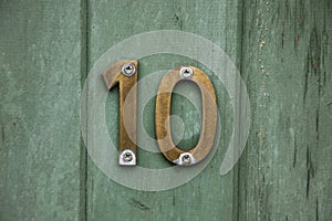 Brass number ten on door