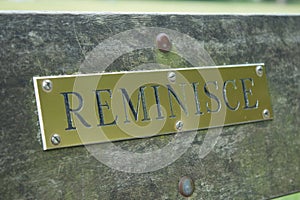 A brass sign saying `reminisce` photo