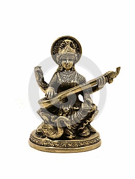 brass statue of saraswathi, goddess of knowledge, art, music, nature and wisdom