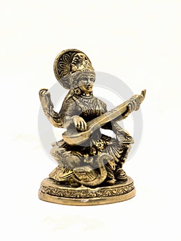 brass statue of saraswathi, goddess of knowledge, art, music, nature and wisdom
