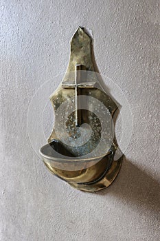 A brass stoup for holy water