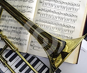 Brass Trombone and classical music laid over synthesizer keyboard.