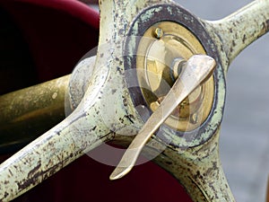 Brass wheel hub with clamping lever of an old four-spoke steering wheel of a vintage racing car